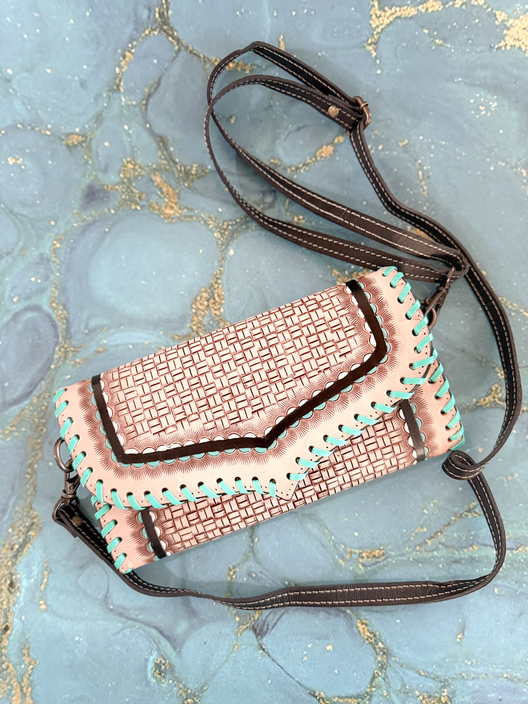 Handmade tooled leather clutch with basketweave design and turquoise whipstitch edges