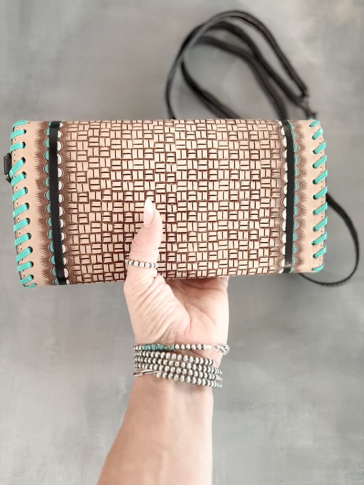 Back view of leather basketweave clutch with turquoise stitching accents