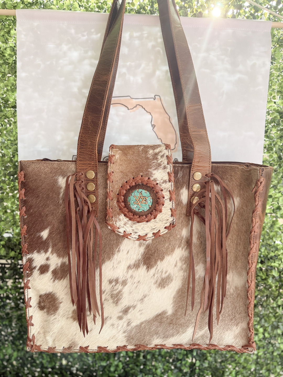 Palomino Bluff tote in hair-on cowhide and brown crunch leather with turquoise concho