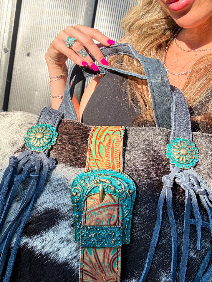 Turquoise buckle detail on cowhide fringe shoulder bag
