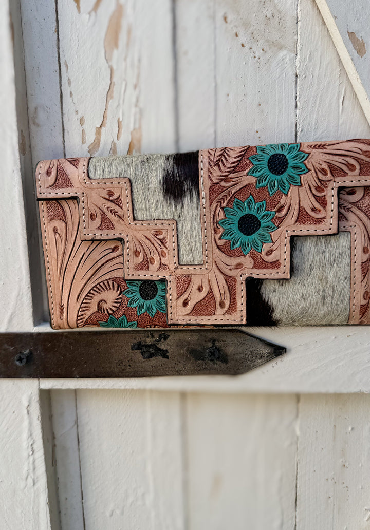 Western cowhide wallet with hand tooled leather floral pattern and turquoise bloom accents