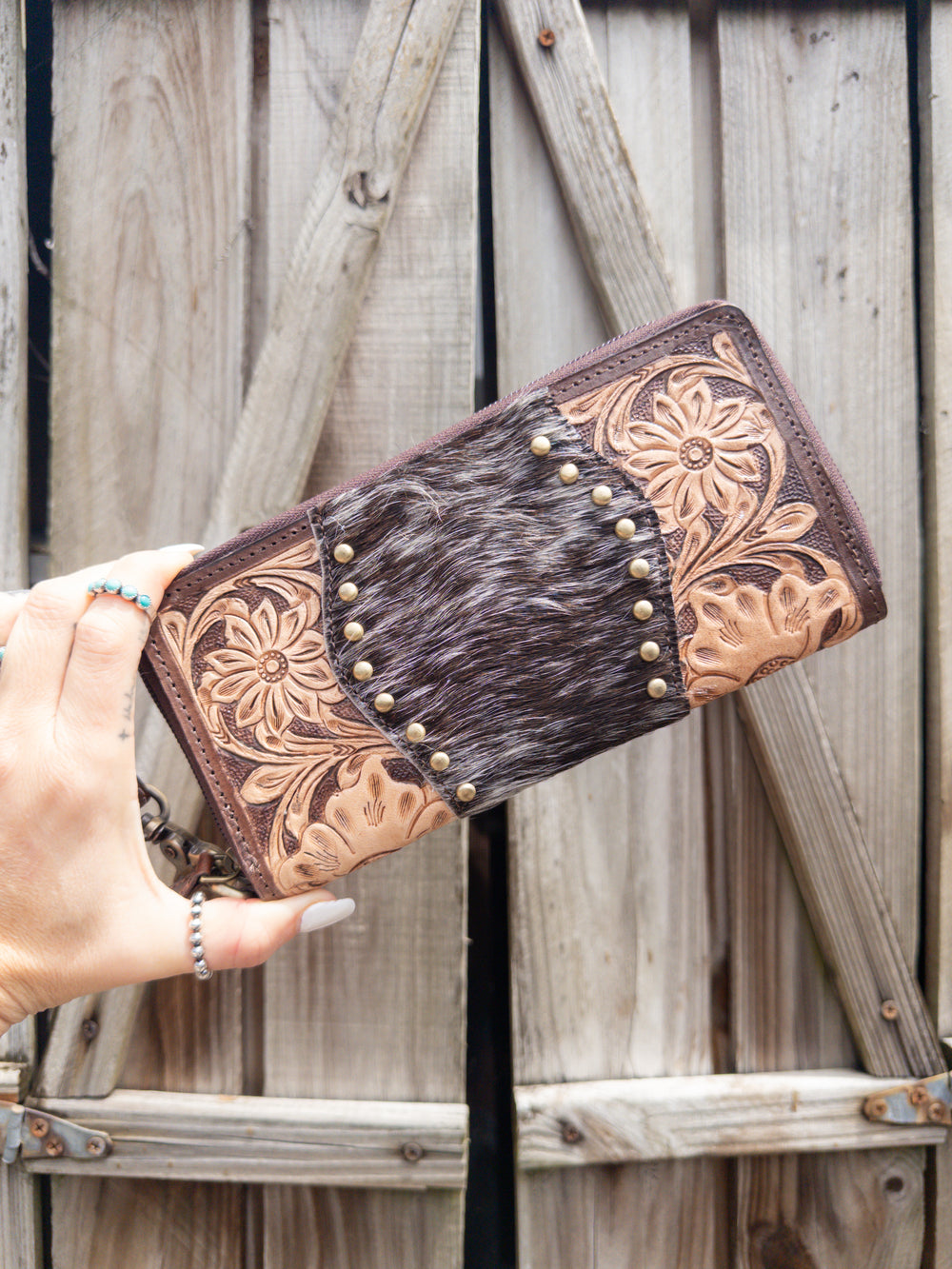 Brown and tan tooled leather women’s western wallet with brown speckled hair on cowhide and gold studs 