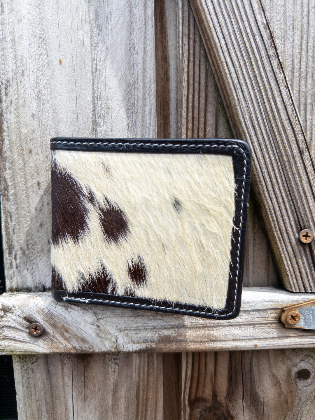 Black hair-on cowhide bifold wallet with black leather interior for men