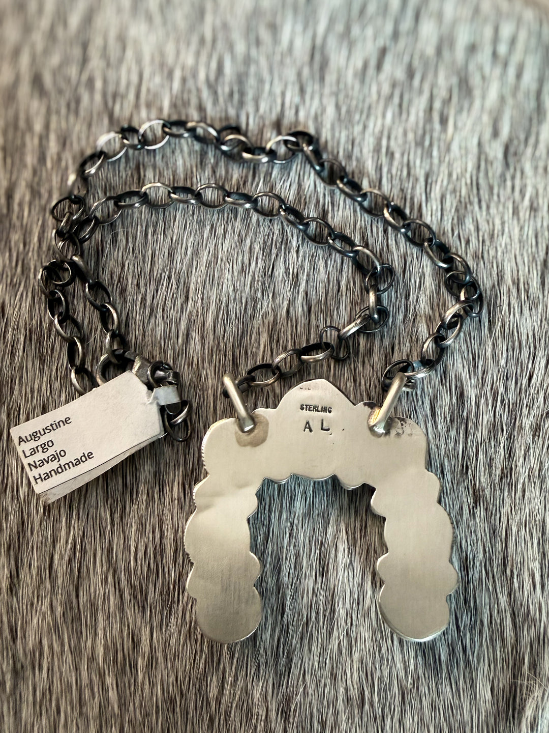 Back view showing makers mark of Navajo sterling silver naja necklace with No. 8 turquoise stones by Augustine Largo on 16 inch chain