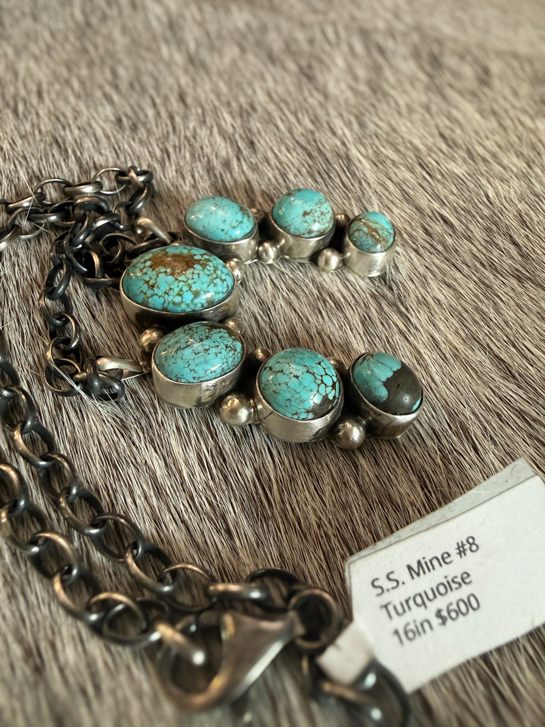 Side view of Navajo sterling silver naja necklace with No. 8 turquoise stones by Augustine Largo on 16 inch chain