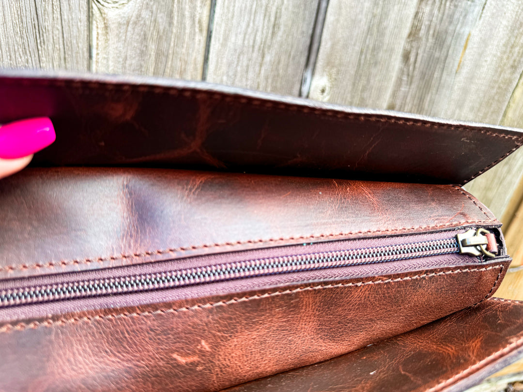 Top zipper opening of concealed carry compartment inside leather tote bag