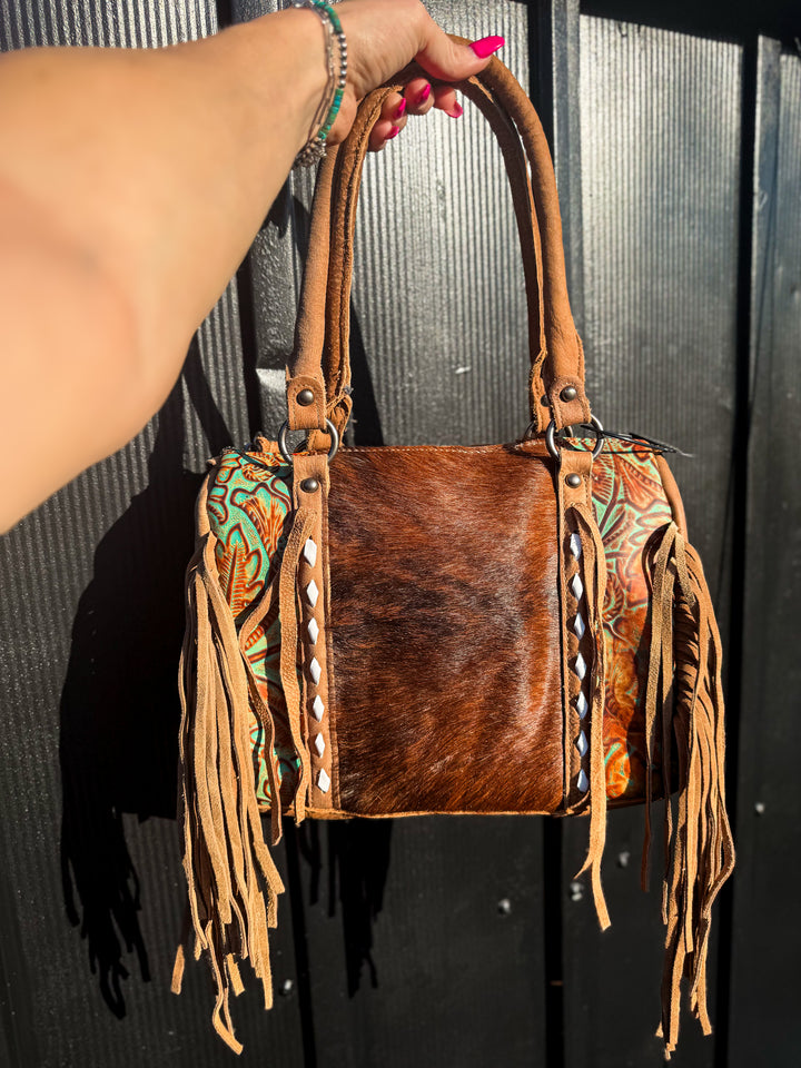 Strapped and stashed brindle cowhide concealed carry fringe speedy bag front view