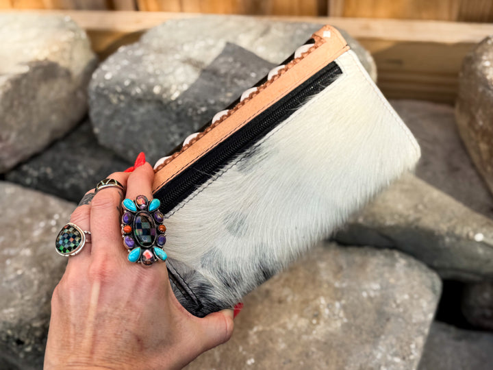 Back side showing external coin zipper pocket of the Speed Check black and ivory checkered leather flap wallet with genuine cowhide and tan leather trim.