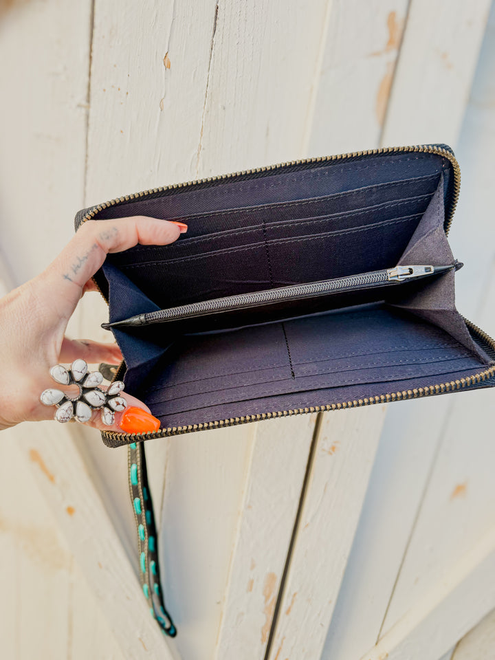 Inside view of the Cowhide zip around wristlet wallet with detachable strap and tooled leather details 