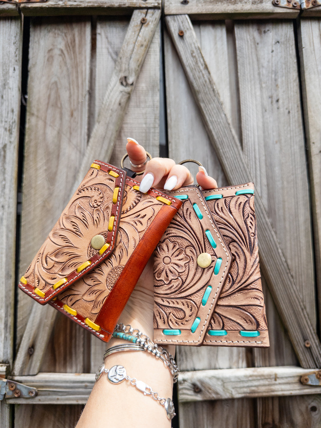 Compact tooled leather keychain wallet with whipstitch trim and single open pocket