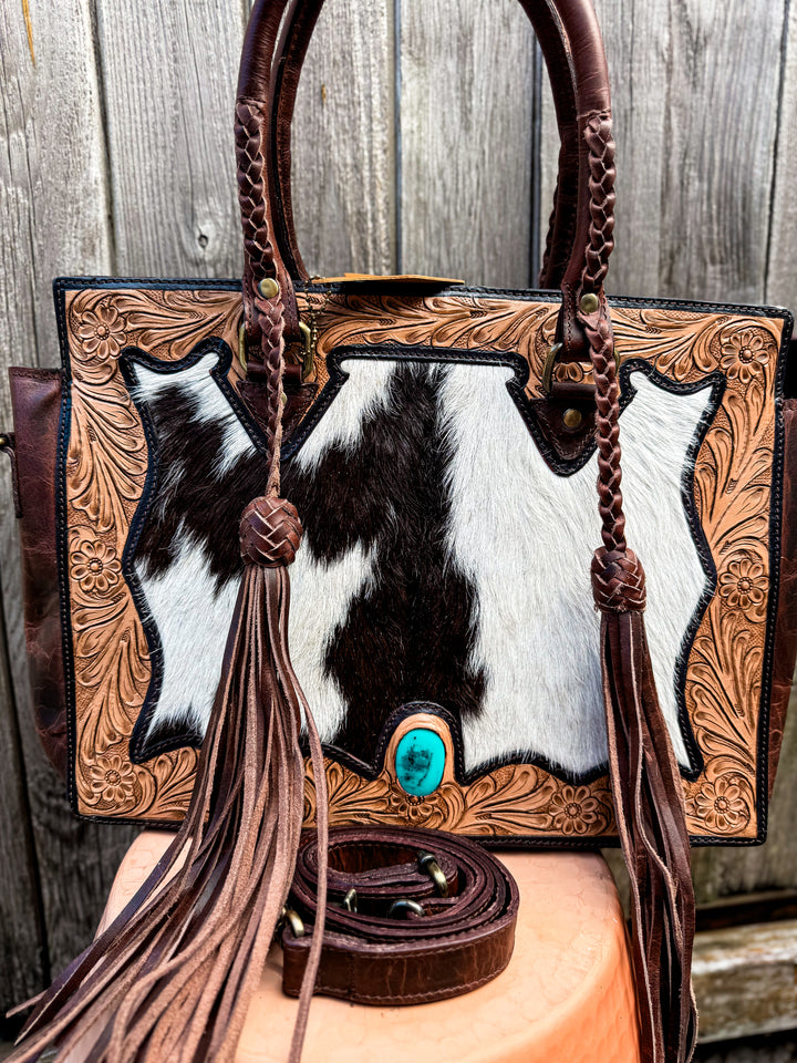 Cowhide and tooled leather concealed carry tote with braided handles and fringe tassels