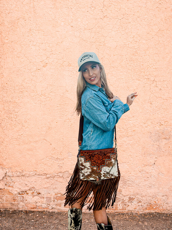 western fringe purse worn crossbody with cowhide pattern