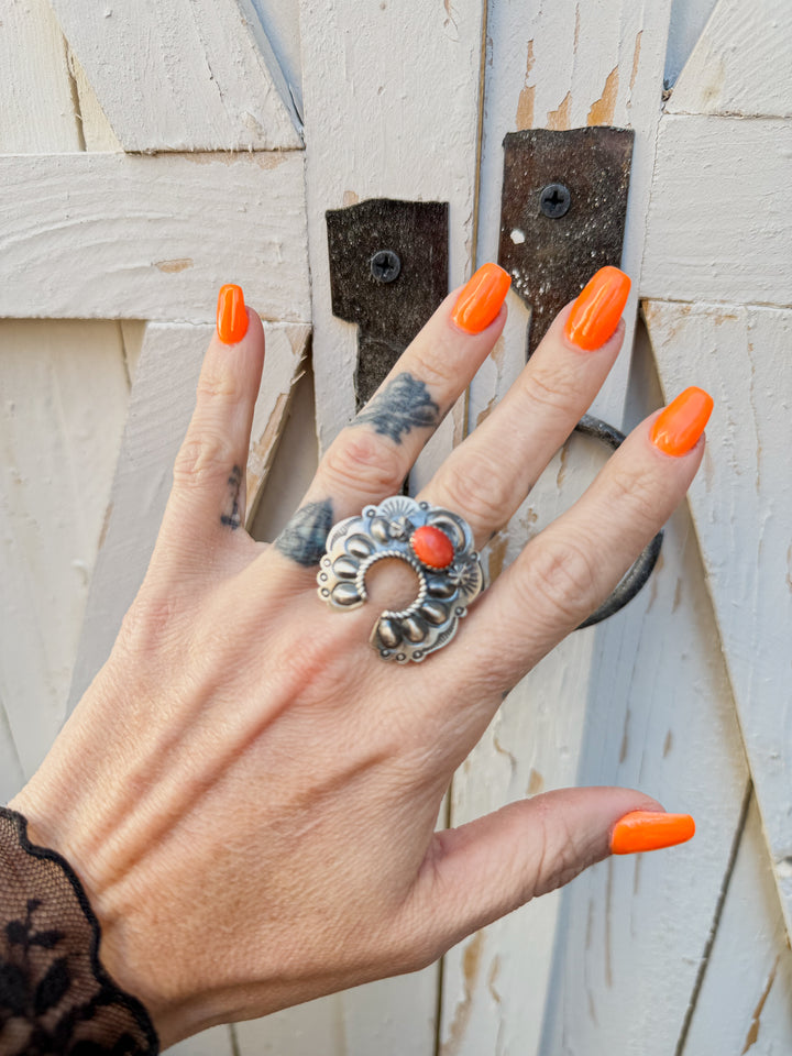 Woman wearing Navajo naja statement ring with spiny oyster stone and sterling silver