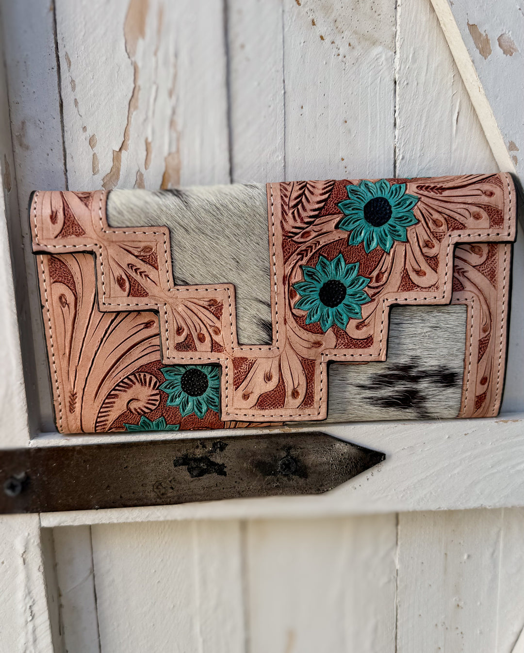 Western black speckled cowhide wallet with hand tooled leather floral pattern and turquoise bloom accents