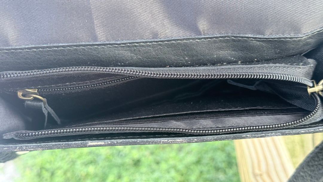 Interior of Speed Check After Dark leather purse showing black fabric lining, zippered main compartment and interior pocket.