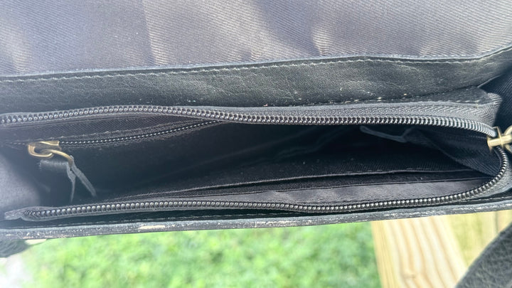 Interior of Speed Check After Dark leather purse showing black fabric lining, zippered main compartment and interior pocket.