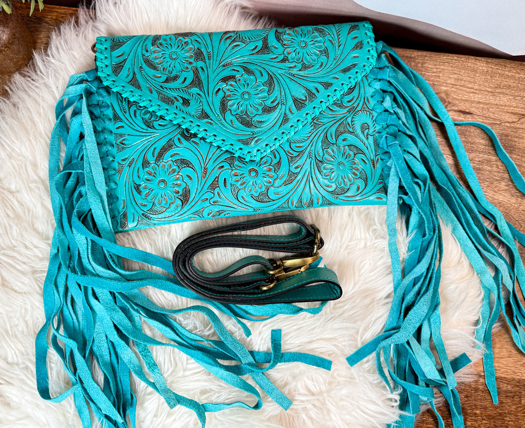 Turquoise tooled leather fringe crossbody with adjustable strap and antique brass hardware