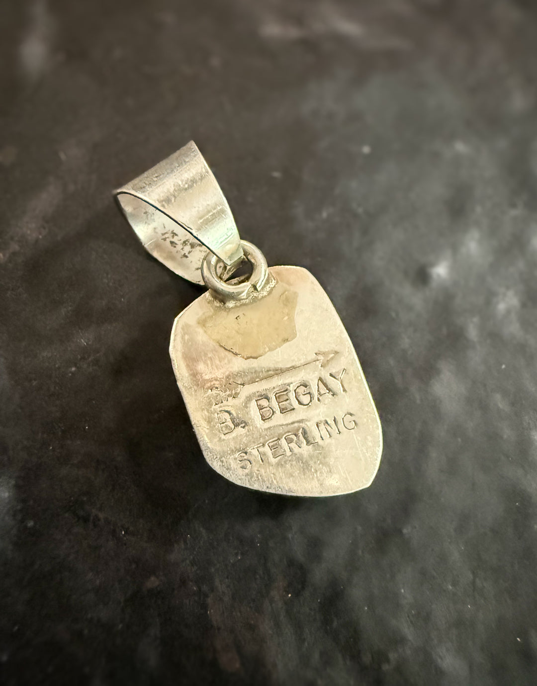 Back of Navajo turquoise pendant stamped B Begay sterling silver