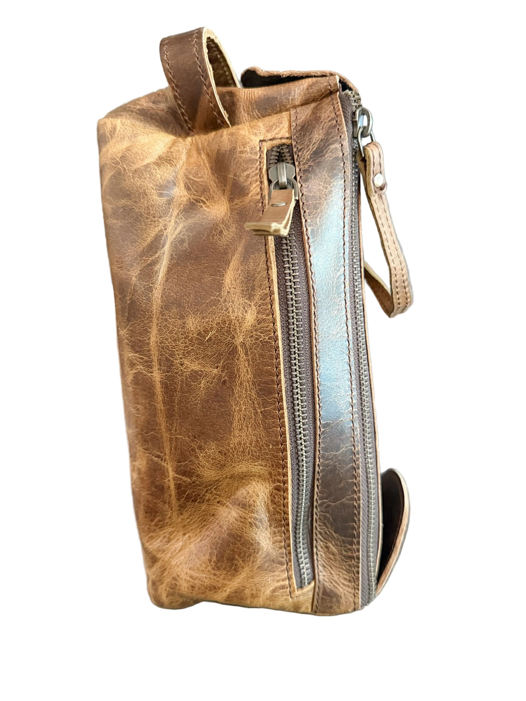 Cognac full grain buffalo leather dopp kit toiletry bag shown from the side with zipper pocket and leather handle