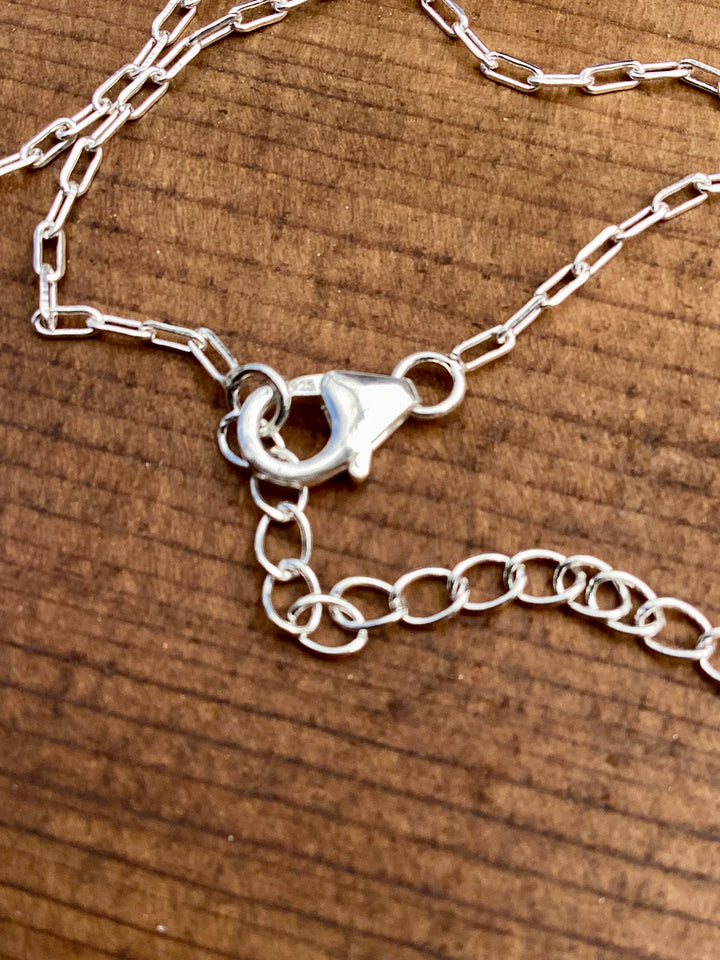 petite sterling silver cross and turquoise charm necklace with adjustable chain
