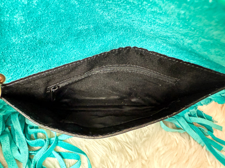 Inside view of turquoise fringe envelope crossbody with interior zipper pocket 