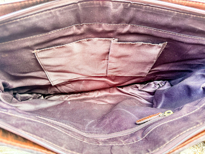 Interior view of leather tote showing slip pockets and zipper pocket storage