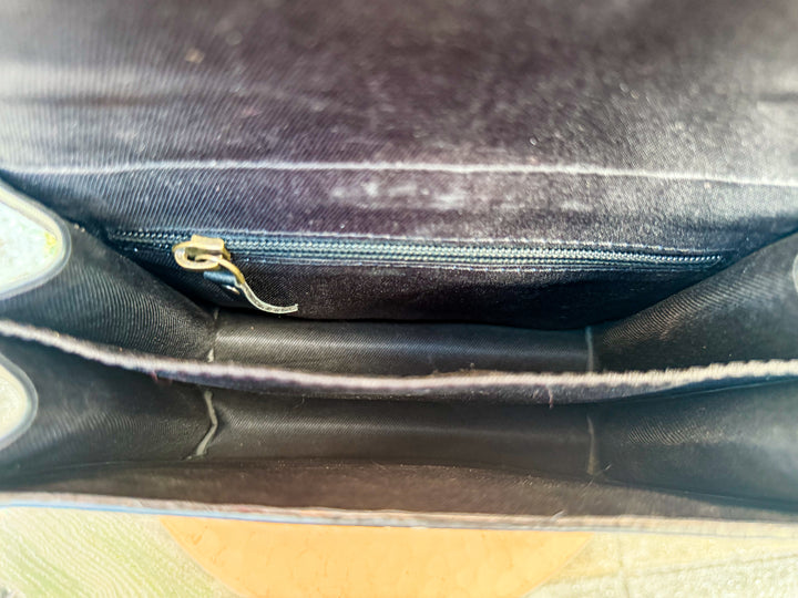 Inside view of Speed Check crossbody bag showing interior zipper pocket and compartment divider