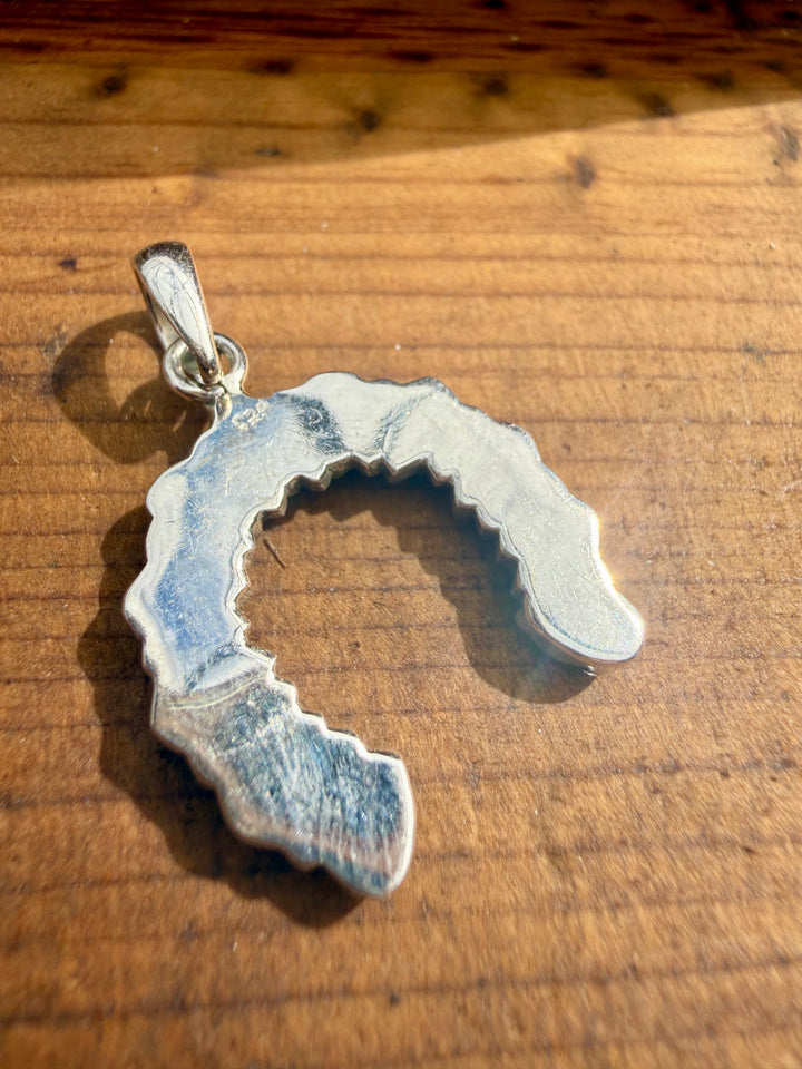 Back side of Sterling silver horseshoe pendant with green blue turquoise stones showing 925 stamp
