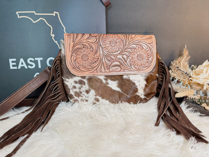 Brown tooled leather cowhide crossbody handbag with intricate patterns from East Coast Carry