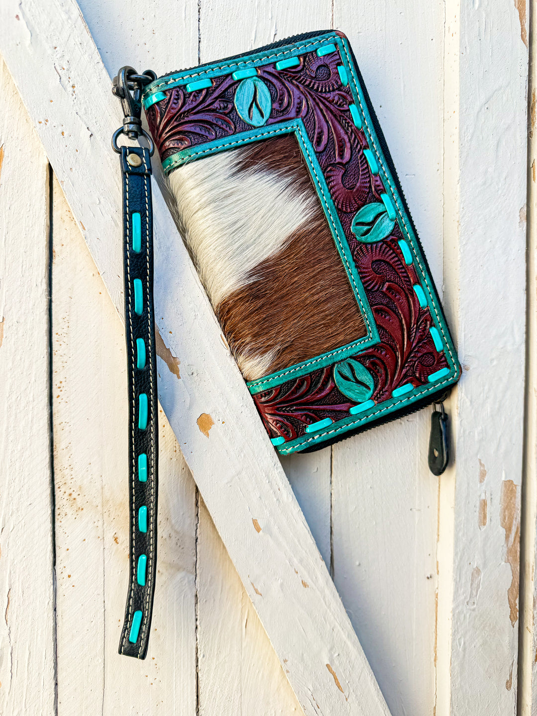 Tooled leather turquoise style phone wristlet close up