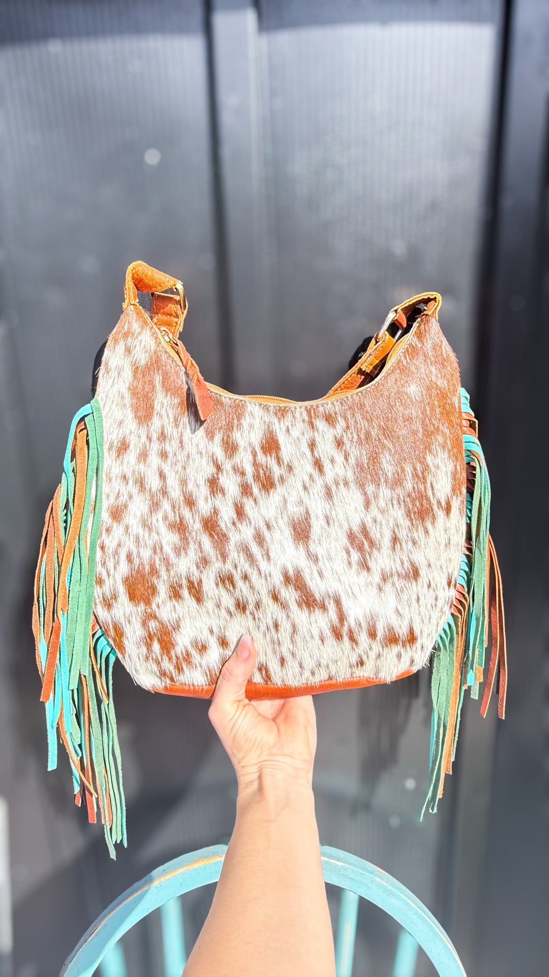 Brown and white speckled cowhide leather shoulder purse with turquoise and brown fringe