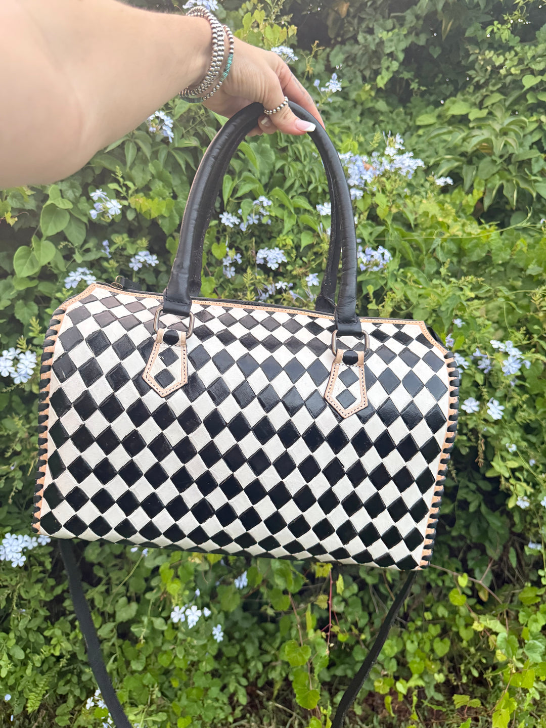 Handmade leather bowler bag in black and white checkered design with double handles.