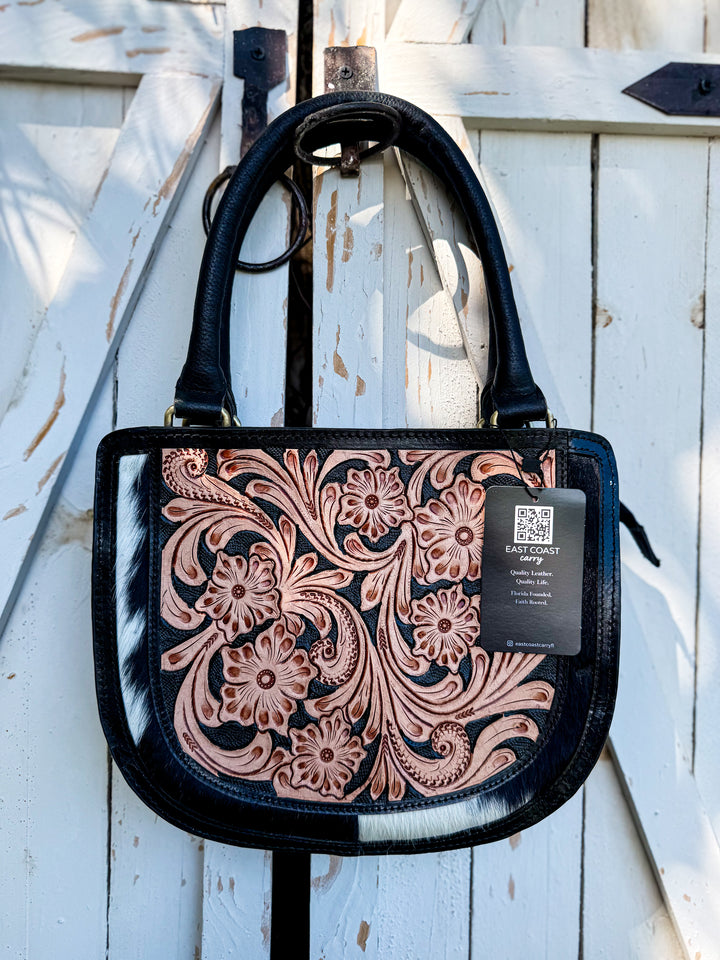 Tooled leather and cowhide crossbody satchel with floral design, top handle, detachable strap, and large back zipper pocket