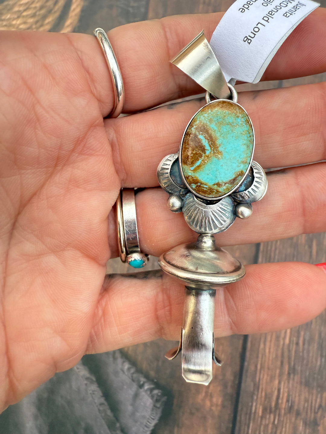 Sterling silver Navajo handmade turquoise blossom pendant close-up