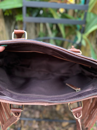 The Frontier Fringe Carryall : Cowhide, tooling, fringe, and function. Includes concealed carry pocket and two ways to wear