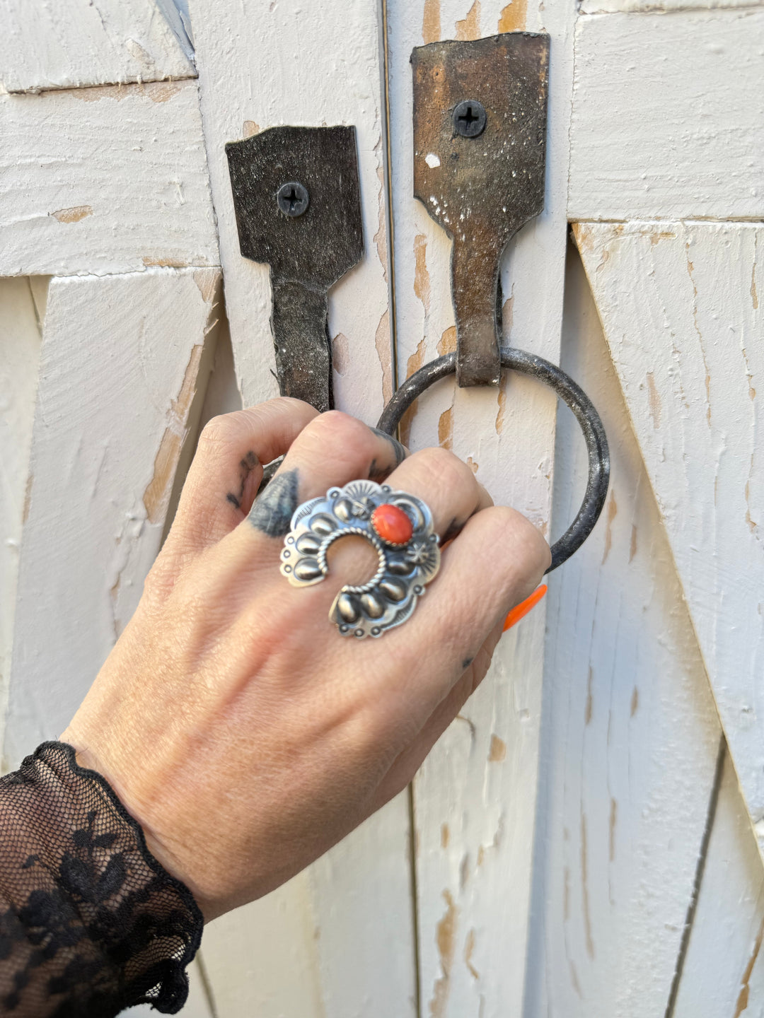 Woman wearing Navajo naja statement ring with spiny oyster stone and sterling silver
