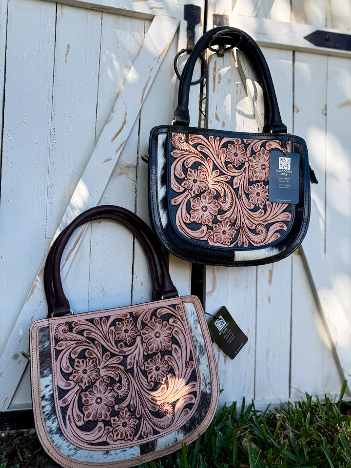 Tooled leather and cowhide crossbody satchel with floral design, top handle, detachable strap, and back pocket
