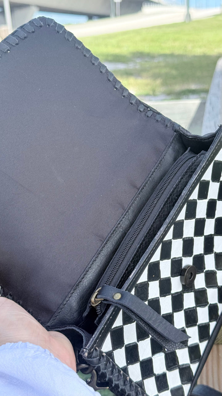 Speed Check After Dark purse with magnetic snap flap open, showing black leather lining and diamond-check front panel.