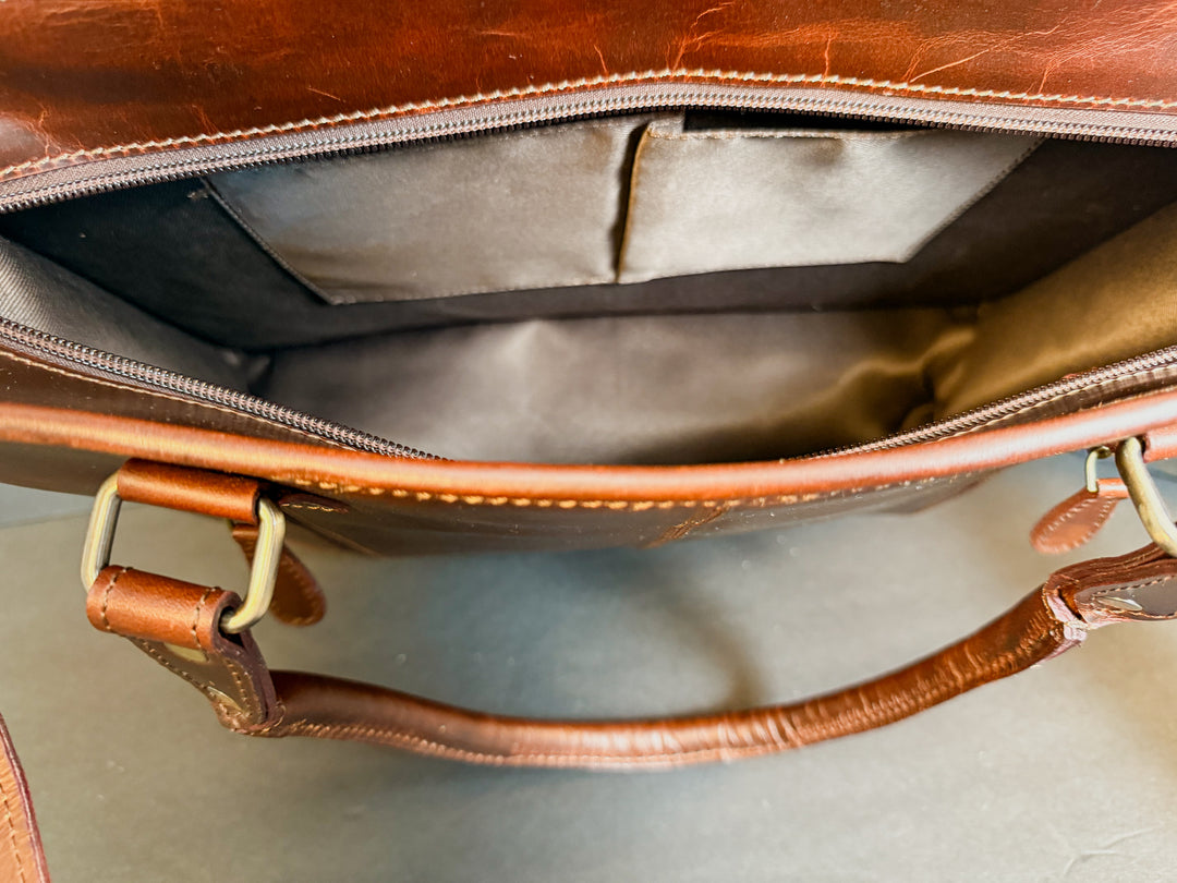 Interior view of checkered full-grain leather tote with cowhide detail.