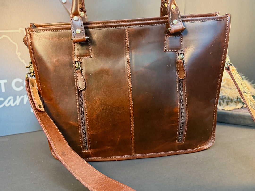 Back view of concealed carry double zipper on checkered full-grain leather tote with cowhide detail
