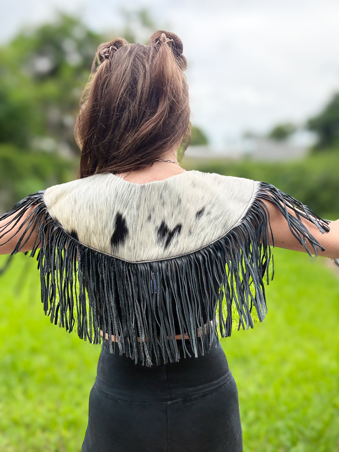 Back view of South Meets West hair-on cowhide Western capelet with long leather fringe