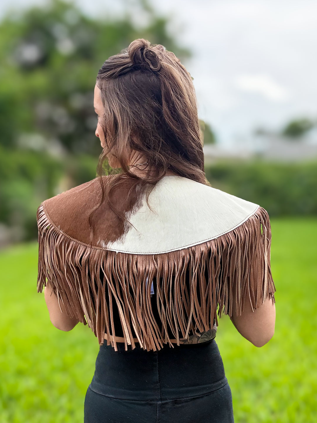 Back view of South Meets West hair-on cowhide Western capelet with long leather fringe