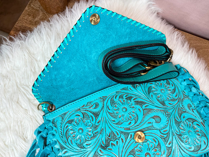 Inside view of turquoise fringe crossbody with strap included