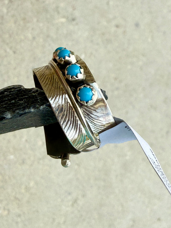 Side view of the Sterling silver adjustable size bypass feather Kingman Turquoise ring handmade by Navajo Chester Charley