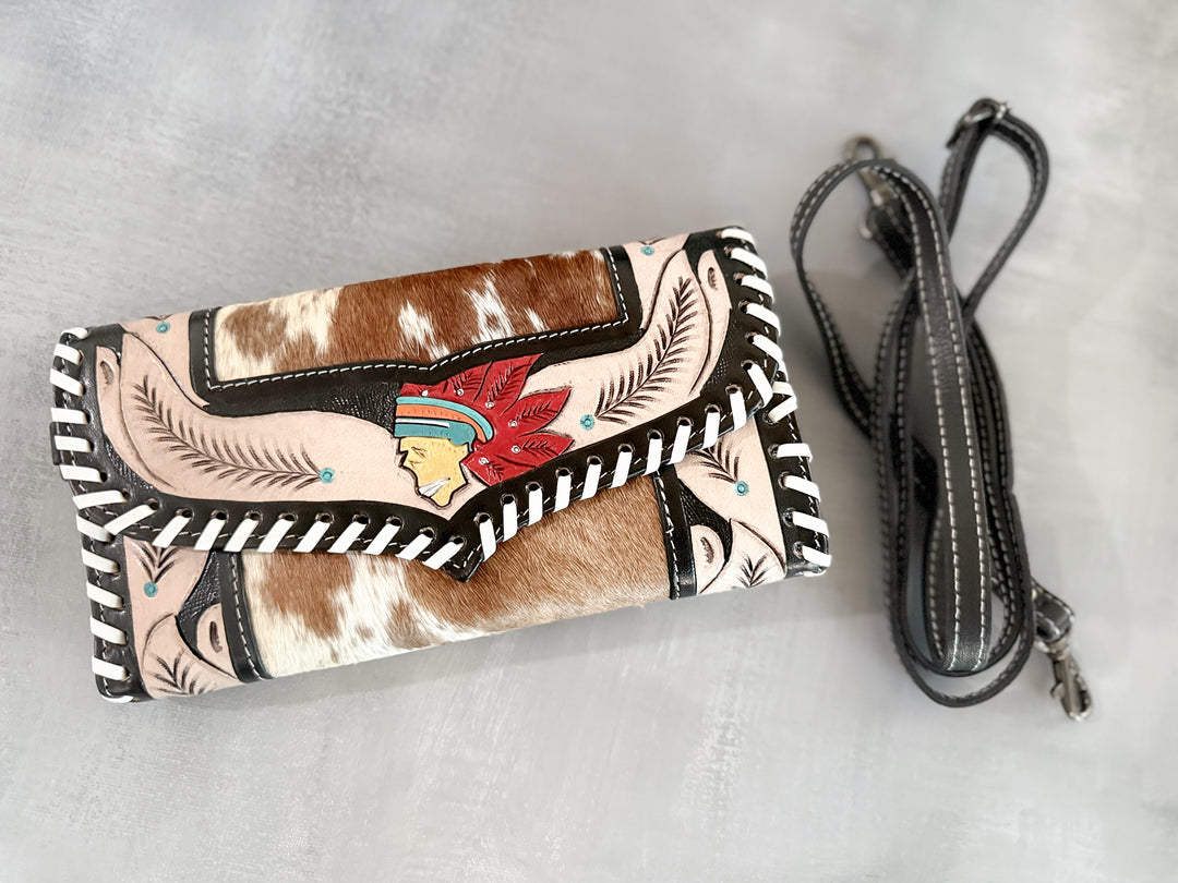 Front view of handmade cowhide and tooled leather clutch with Indian head centerpiece and feather tooling