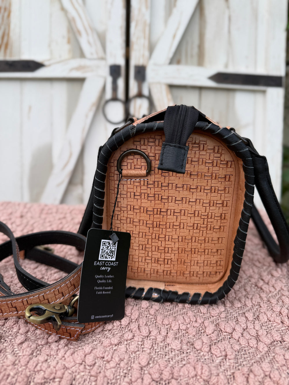 Western tooled leather speedy bag with cowhide panel and rhinestone studs. Medium structured handbag with crossbody strap and concealed carry space.