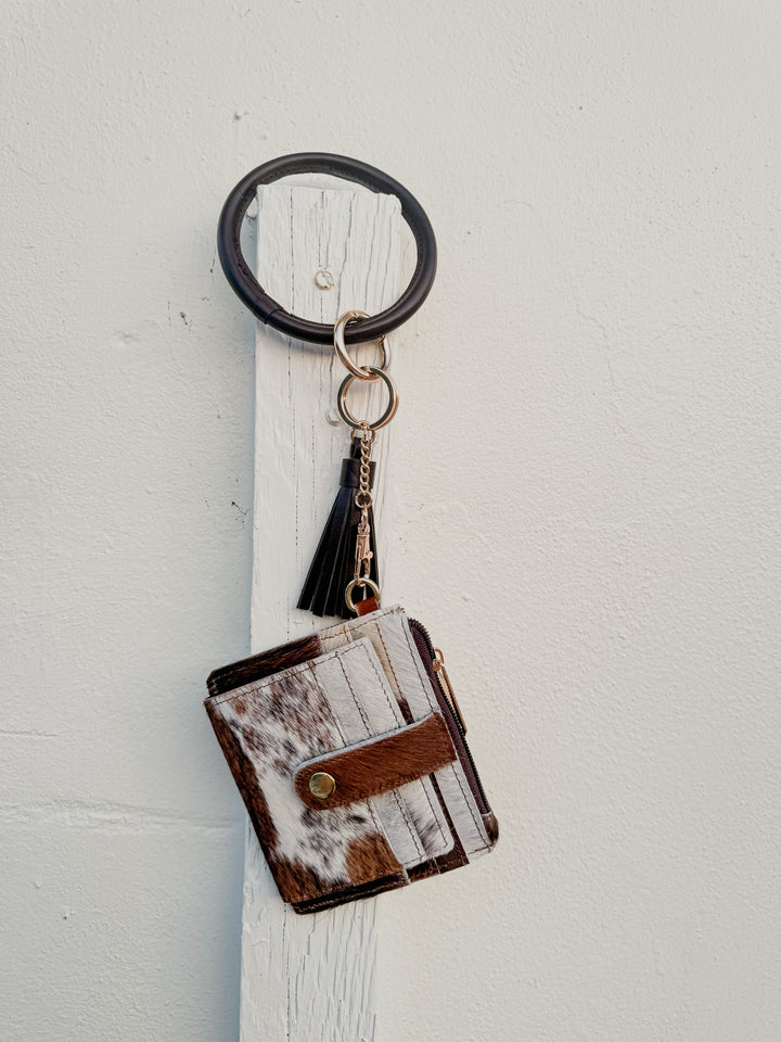 Light cowhide bangle wristlet wallet with snap card strap and dark brown bangle keyring.