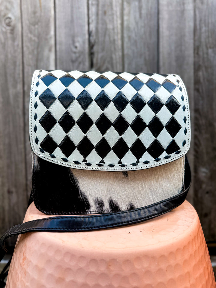 Speed Check side saddle crossbody purse with black and white checkered flap and cowhide front panel