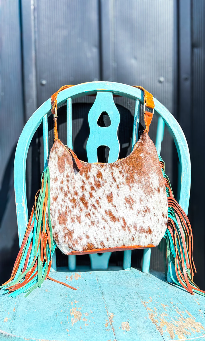 Brown and white speckled cowhide leather shoulder purse with turquoise and brown fringe