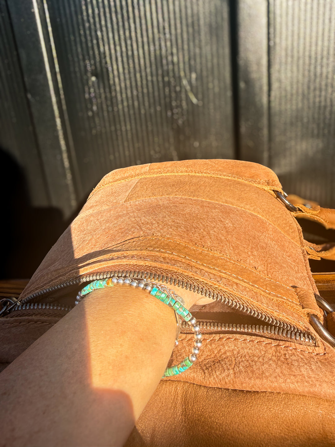 Back zipper right hand concealed carry pocket with a hand inside to show function 